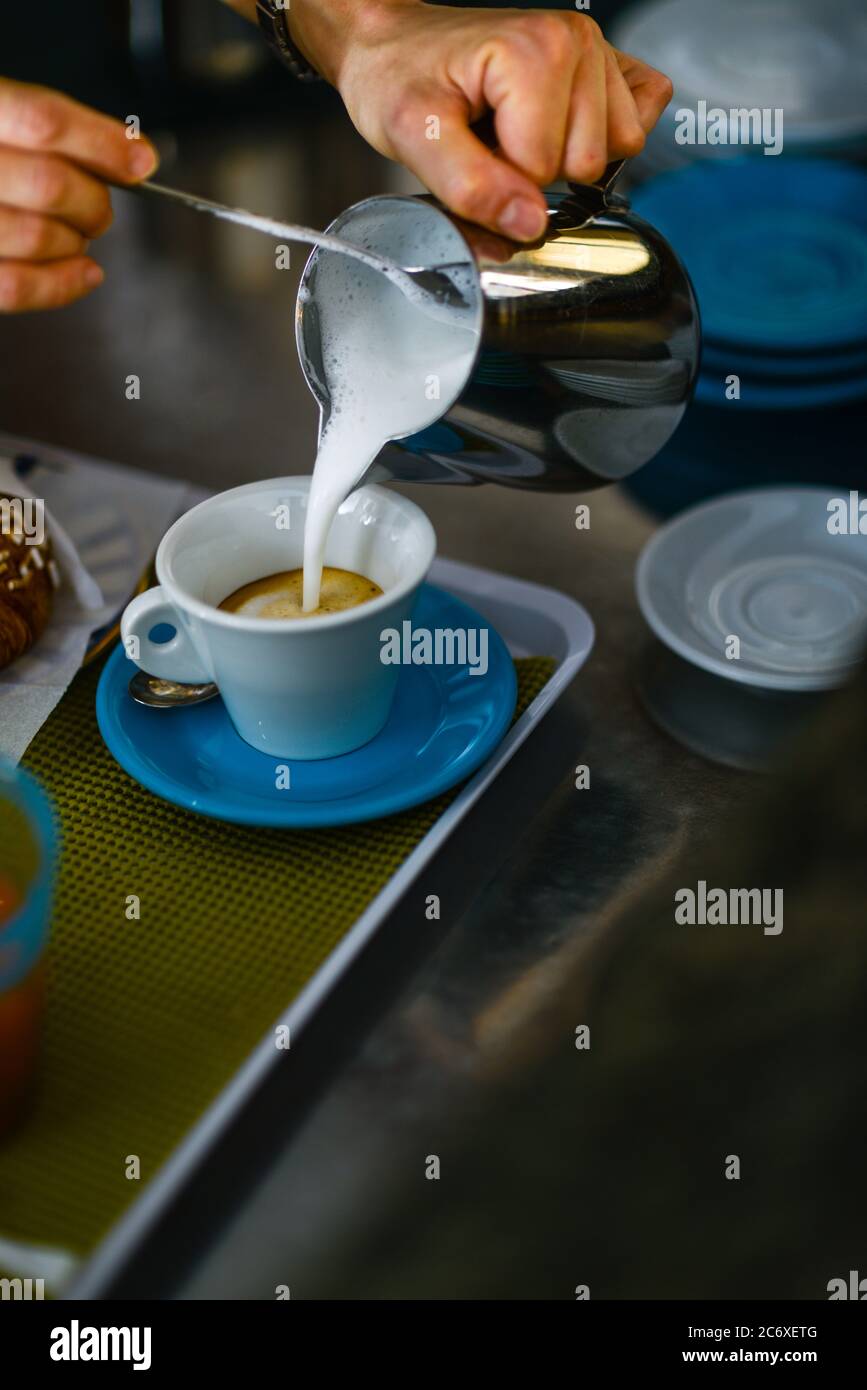 Hands of young adult caucasian female barista at work preparing Stock Photo