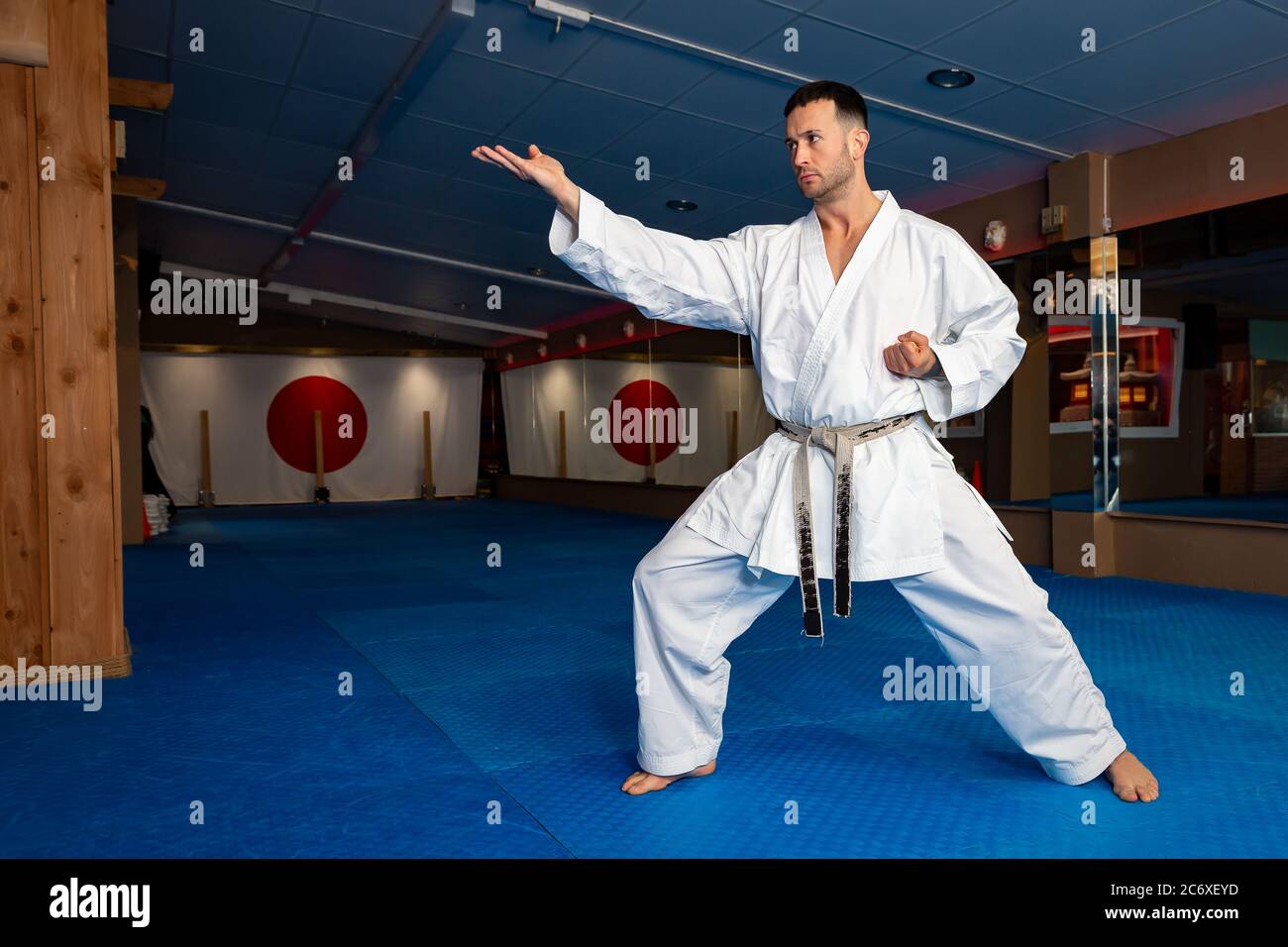 Karate man stand your ground on tatami doing "Shuto Uchi" Stock Photo