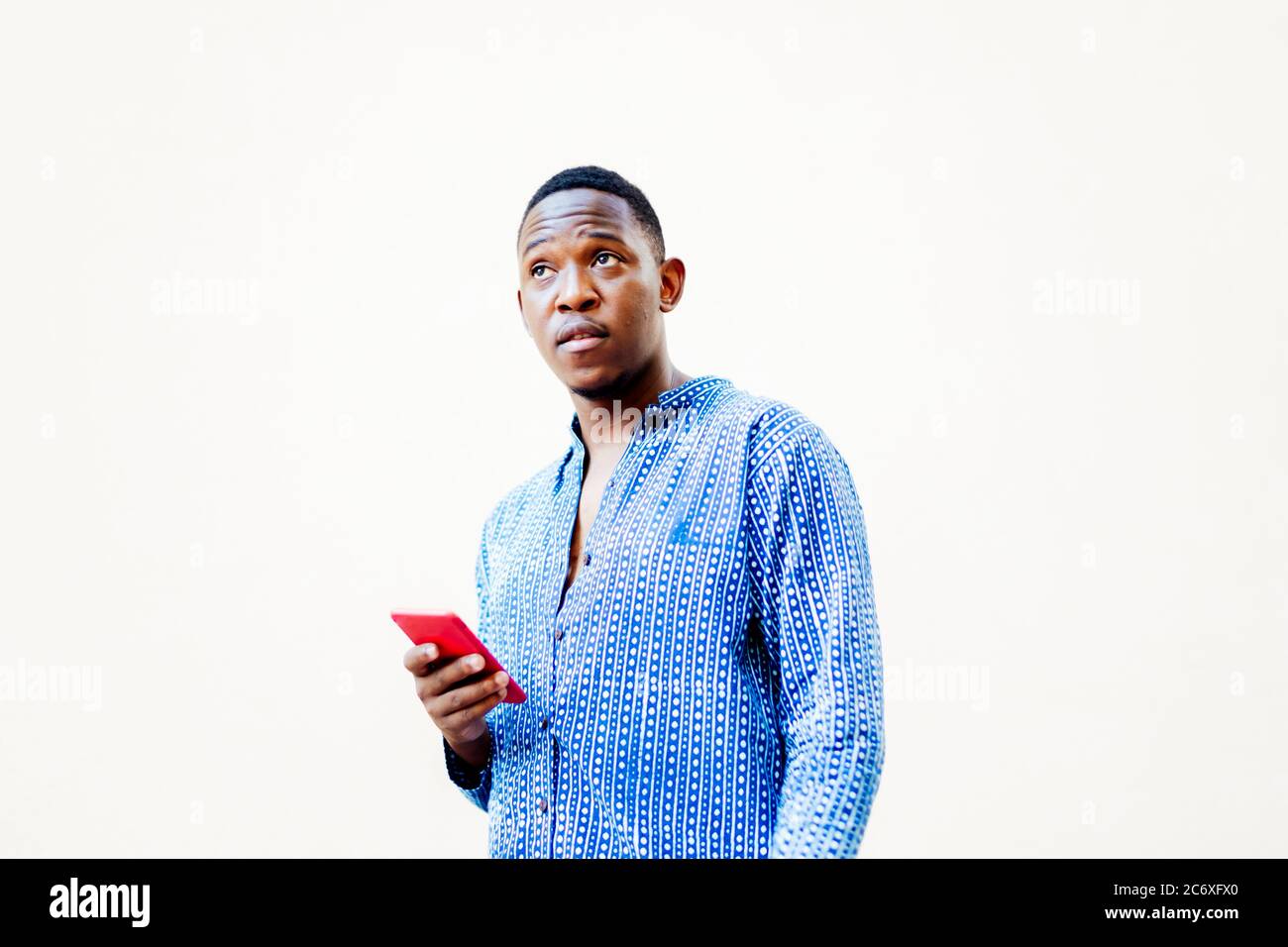 young black man with his smartphone in hand Stock Photo