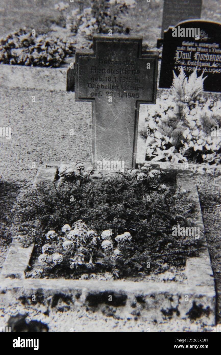 Fine 70s vintage black and white lifestyle photography of a gravestone of a victim of the Bombing of Dresden. Stock Photo