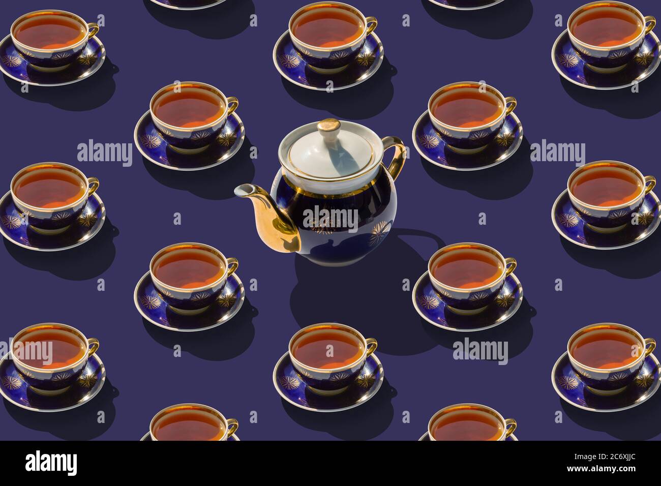 Many cups of tea and one teapot in the center. Flat lay, top view