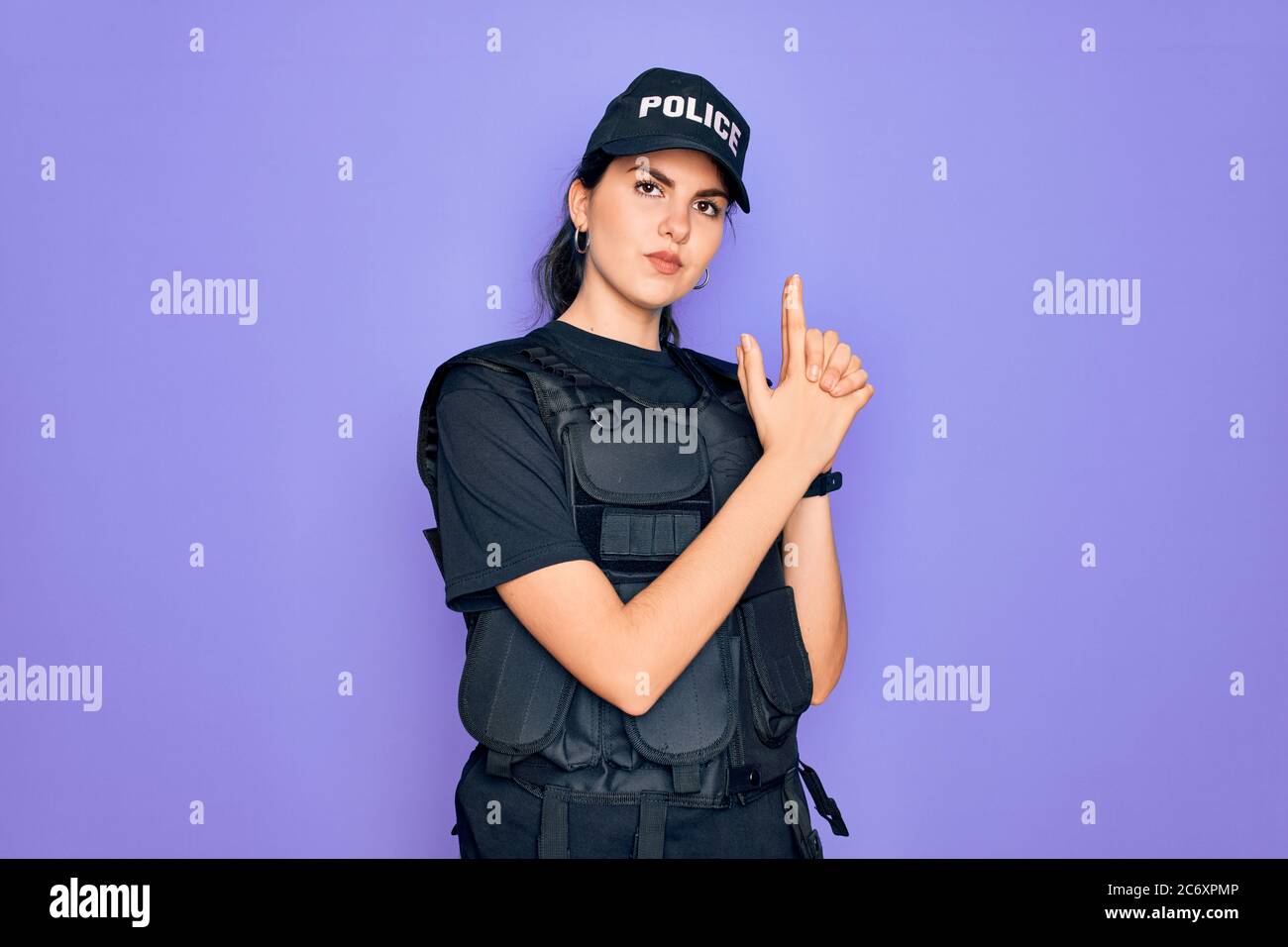 Young Police Woman Wearing Security Bulletproof Vest Uniform Over Purple  Background Pointing Down With Fingers Showing Advertisement Surprised Face  And Open Mouth Stock Photo - Download Image Now - iStock