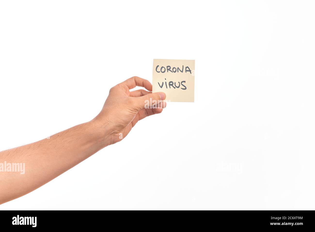 Hand Of Caucasian Young Man Holding Reminder Paper With Corona Virus Message Over Isolated White Hand Of Caucasian Young Man Holding Reminder Paper With Corona Virus Message Over Isolated White