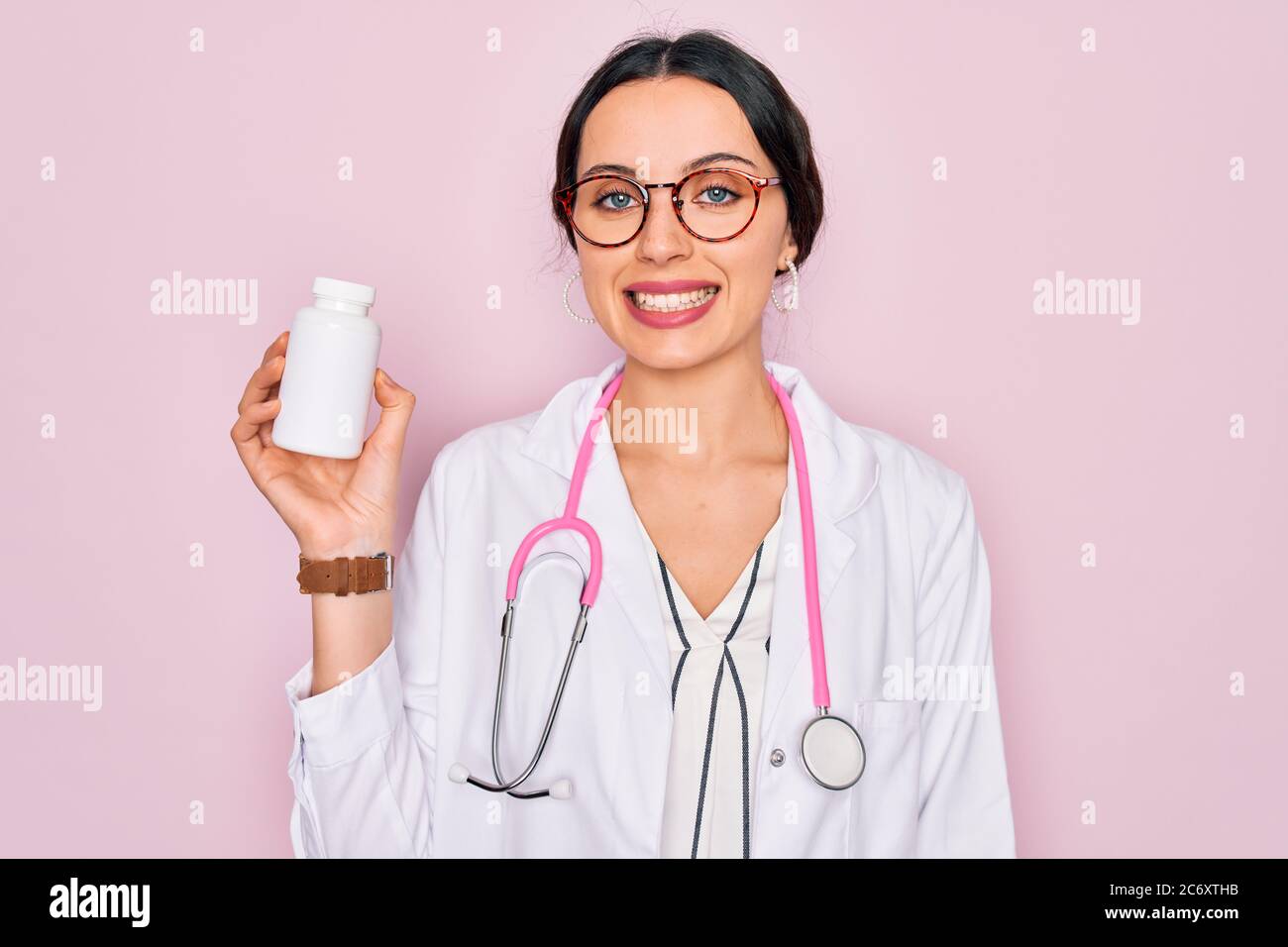 Young beautiful doctor woman with blue eyes wearing stethoscope holding ...