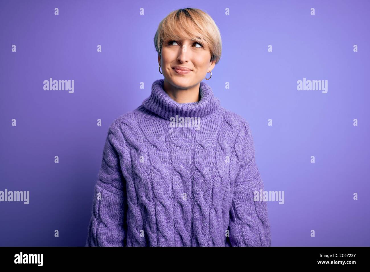 Young blonde woman with short hair wearing winter turtleneck sweater ...