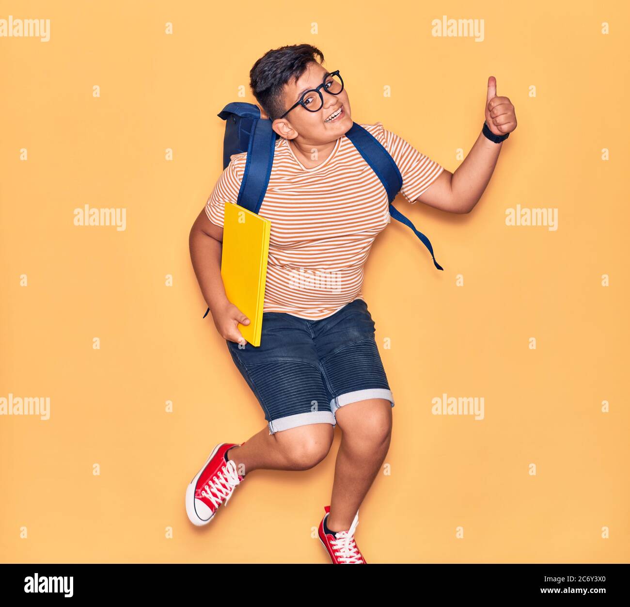 Adorable student boy wearing glasses and backpack smiling happy ...