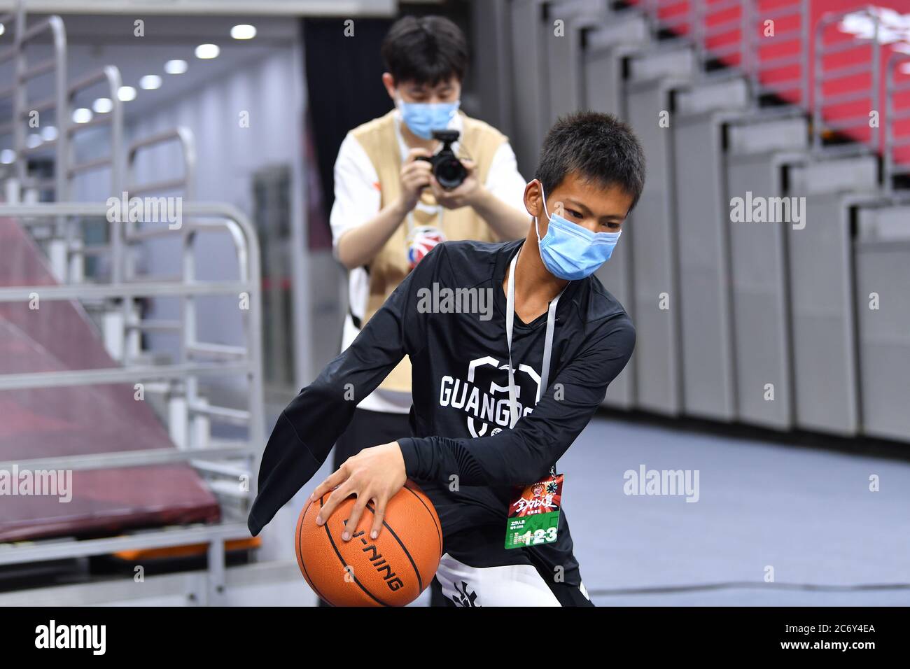 Zhang Jiacheng, an internet sensation, youth basketball player with one arm, practices basketball before a CBA game between Guangdong Southern Tigers Stock Photo