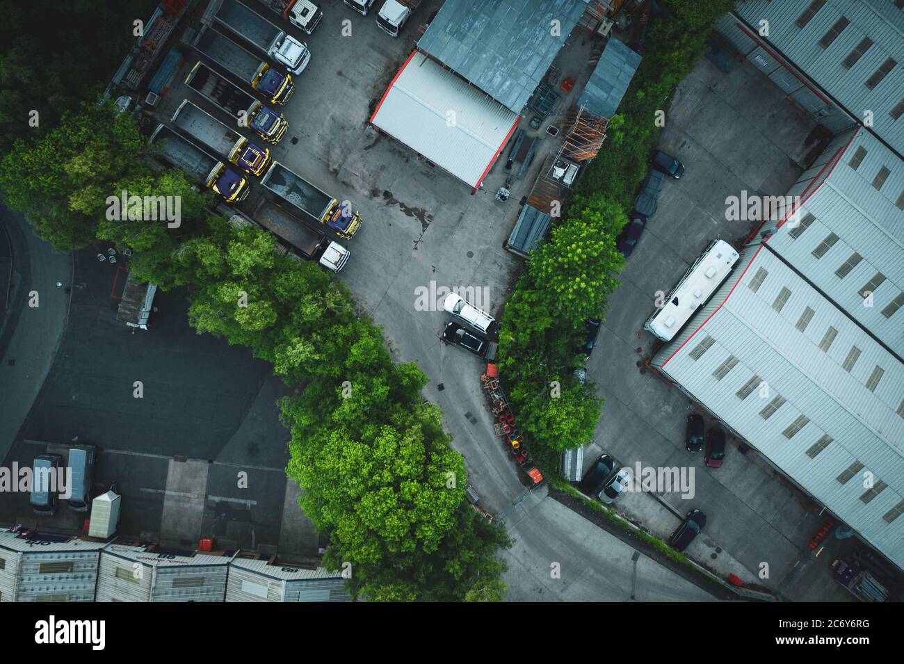 Top down aerial view over industrial buildings at summer evening Stock Photo