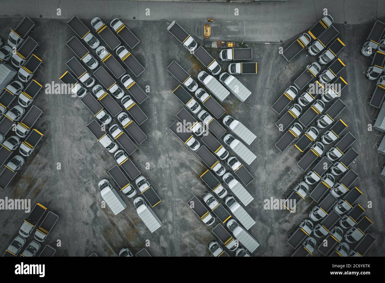 Top down aerial view over parking lot with many delivery trucks parked up during Covid-19 lockdown in United Kingdom Stock Photo