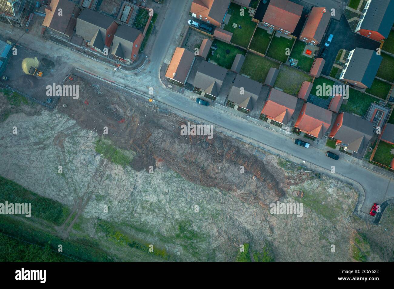 Top down aerial view over residential area with land for housing development in United Kingdom Stock Photo