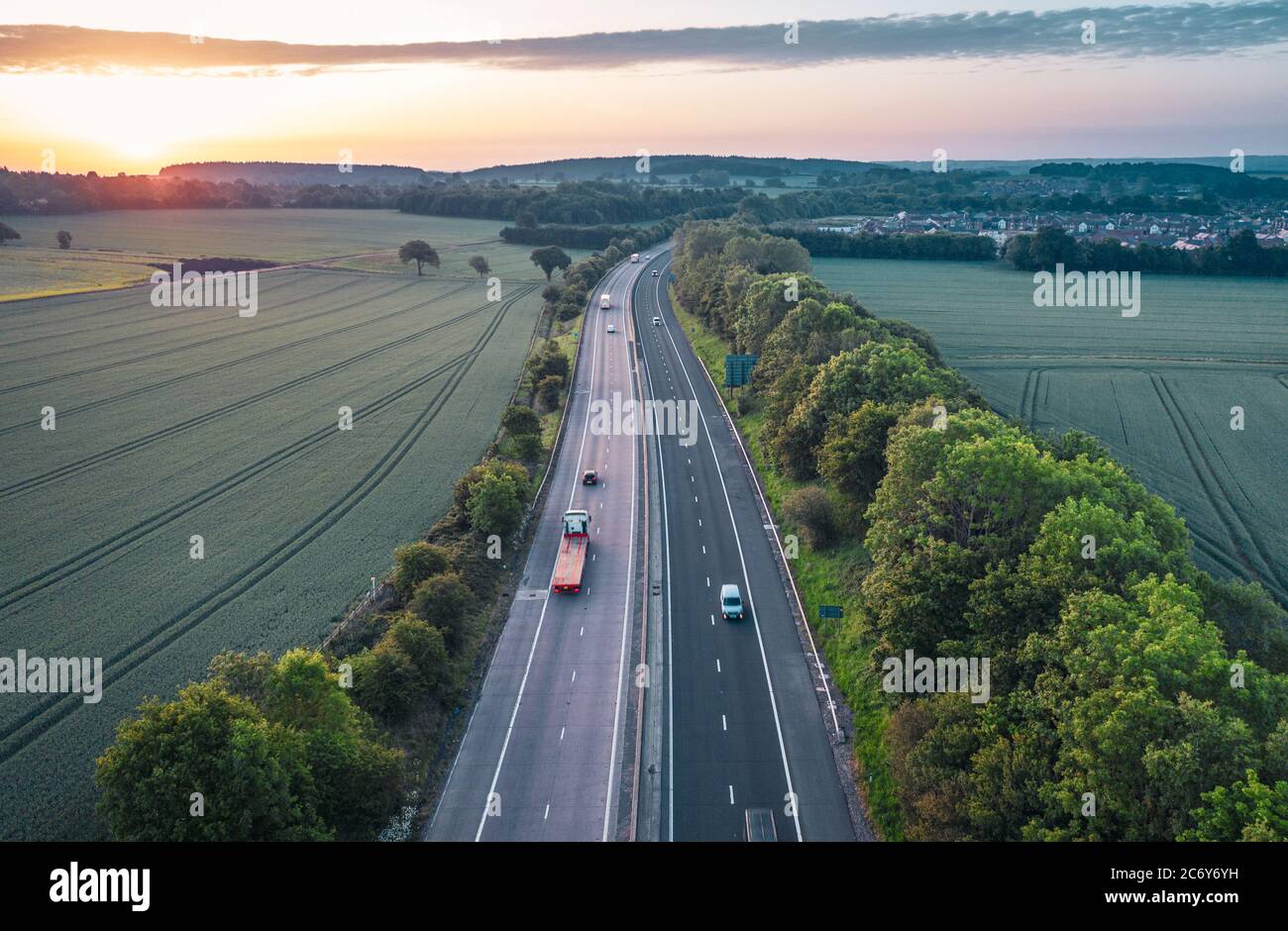 Aerial view over dual lane motorway across scenic countryside at sunrise in United Kingdom Stock Photo