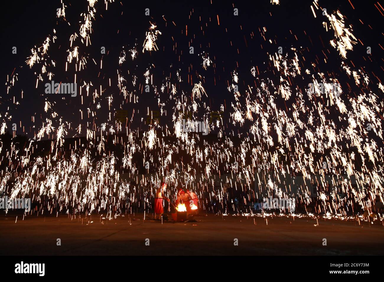 Artists perform molten iron splash at a night market on Dongbei Street in Changchun city, northeast China's Jilin province, 11 June 2020. Stock Photo