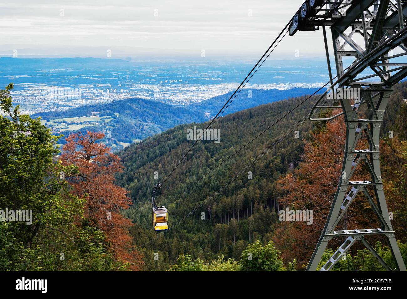 Freiburg, Germany. 30th June, 2020. A support of the Schauinsland cable car  is located near the top station on the Schauinsland while a gondola travels  downhill. The Schauinslandbahn is the longest cable