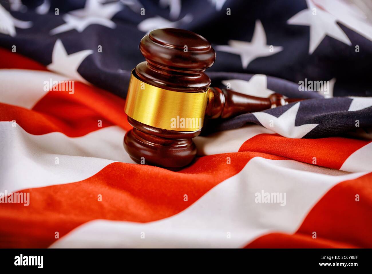 Wooden judge hammer on american flag of office Justice and law Stock Photo