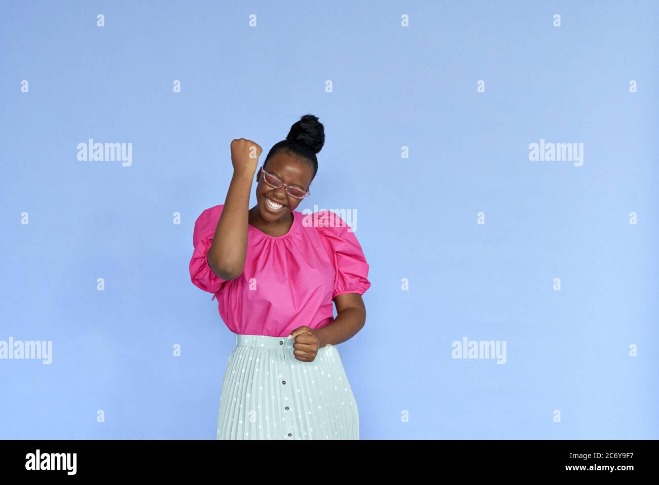 Excited young african woman celebrating win in yes isolated on lilac background. Stock Photo