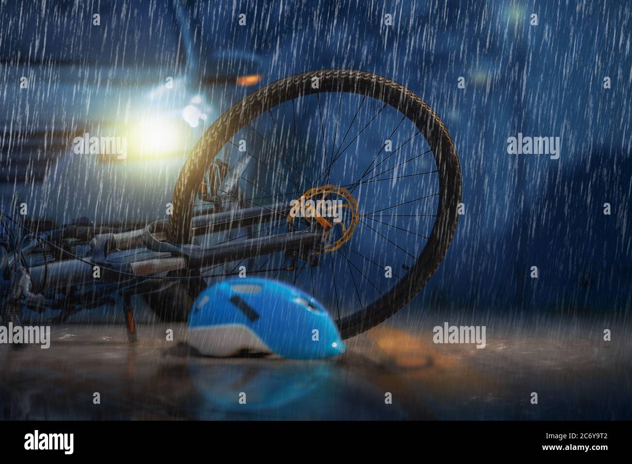 Accident car crash with bicycle on road in rainy weather Stock Photo