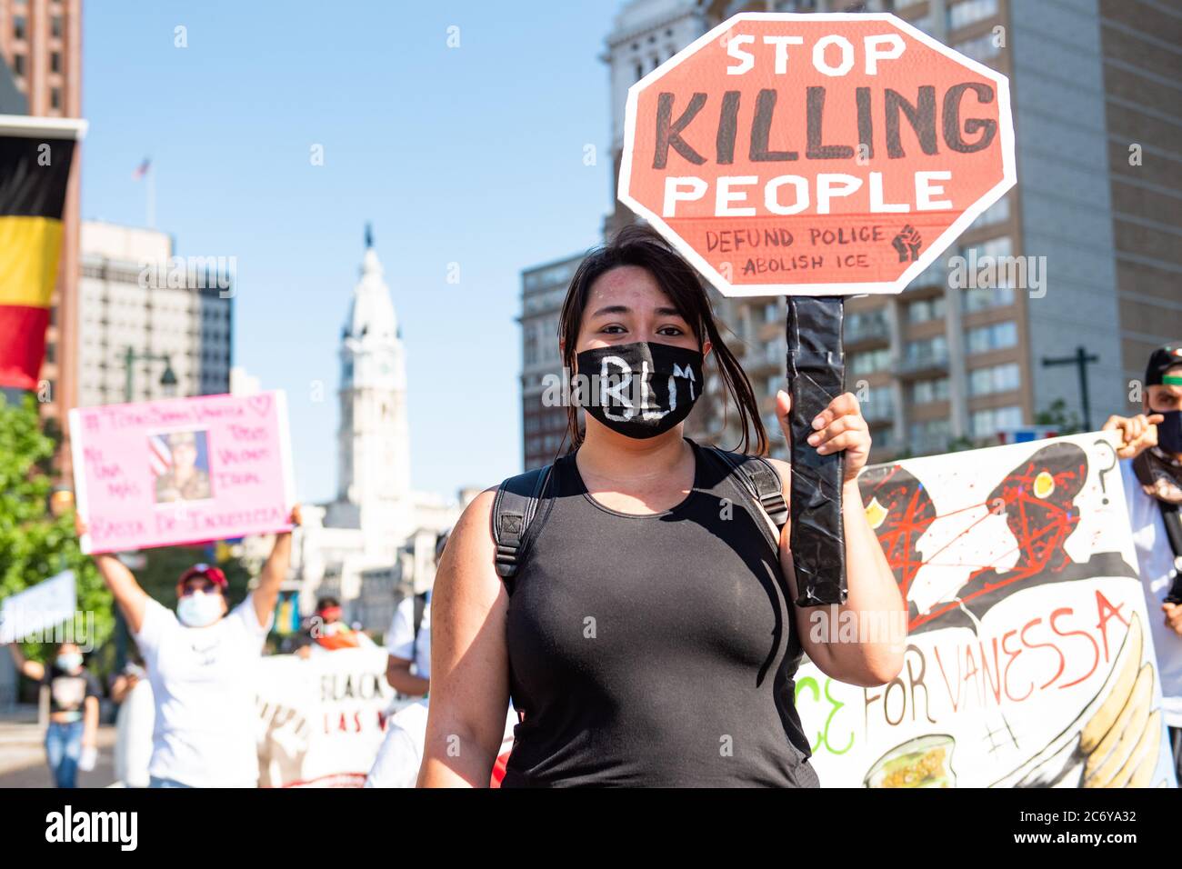 Philadelphia / USA. A woman holds a sign saying, Stop Killing People, during a march in Center City organized by Philadephia Latinx organizatoin, Juntos. July 12, 2020. Credit: Christopher Evens / Alamy Live News Stock Photo