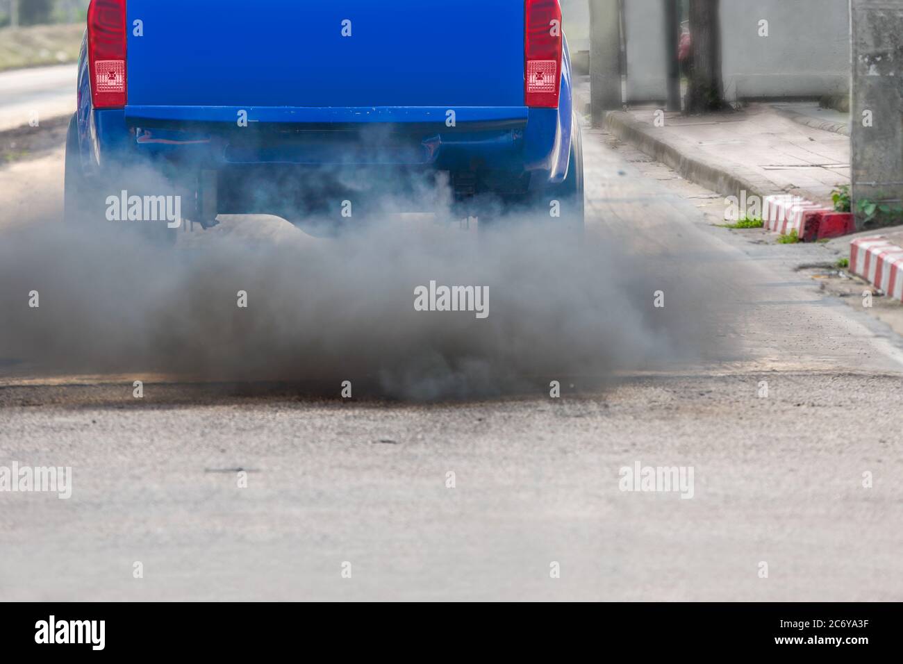 air pollution crisis in city from diesel vehicle exhaust pipe on road Stock Photo
