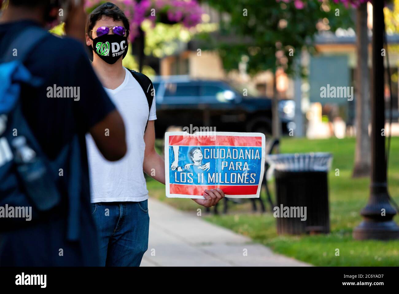 A protester holds a sign supporting citizenship for the 11 million undocumented immigrants in the United States, Washington, DC, United States Stock Photo