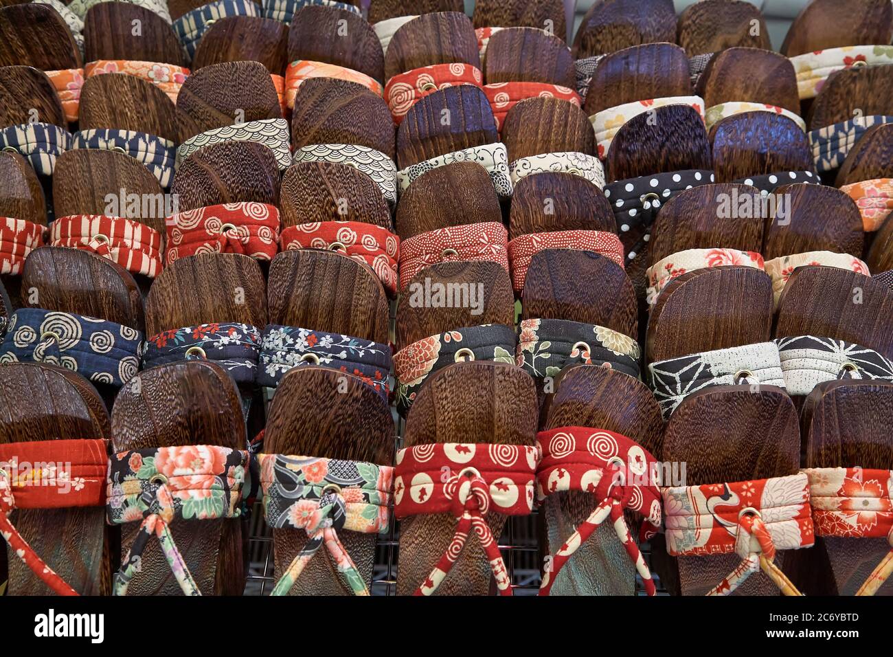KYOTO, JAPAN - OCTOBER 22, 2007: The colorful female japanese wooden clogs geta sandals, made of silk, exposed on the counter at the market of Kyoto. Stock Photo