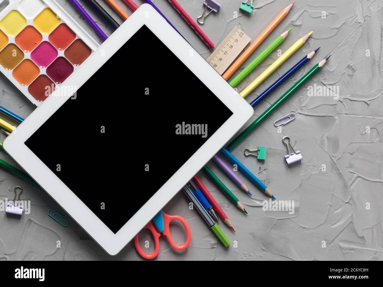 School supplies center composition on grey .concrete background Stock Photo
