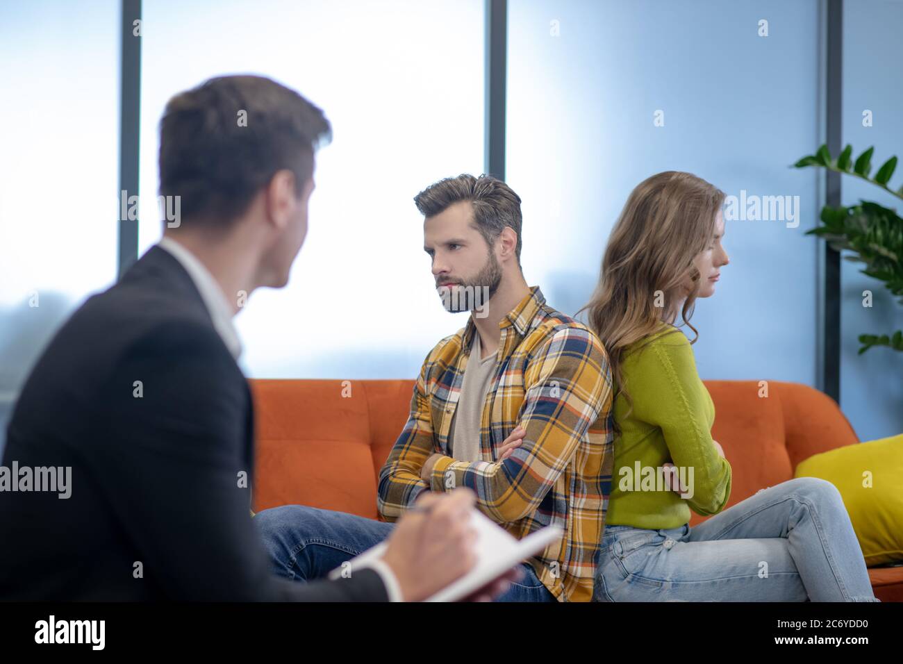 Young couple solving their argument with a psychotherapist Stock Photo
