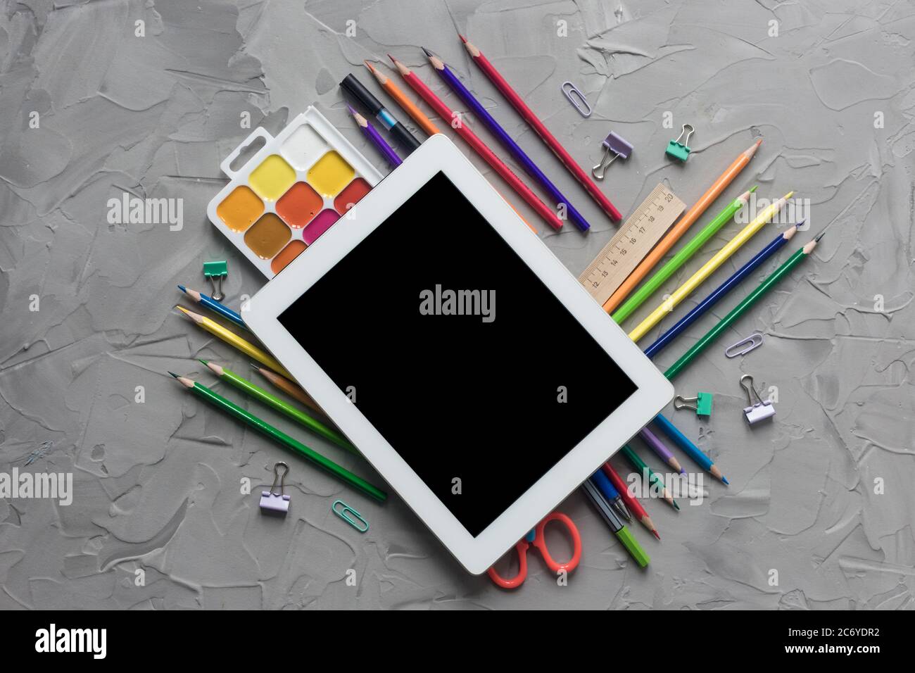 School supplies center composition on grey .concrete background Stock Photo