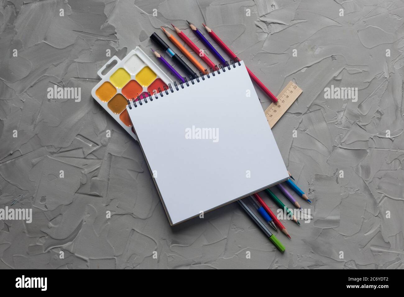 School supplies center composition on grey .concrete background Stock Photo