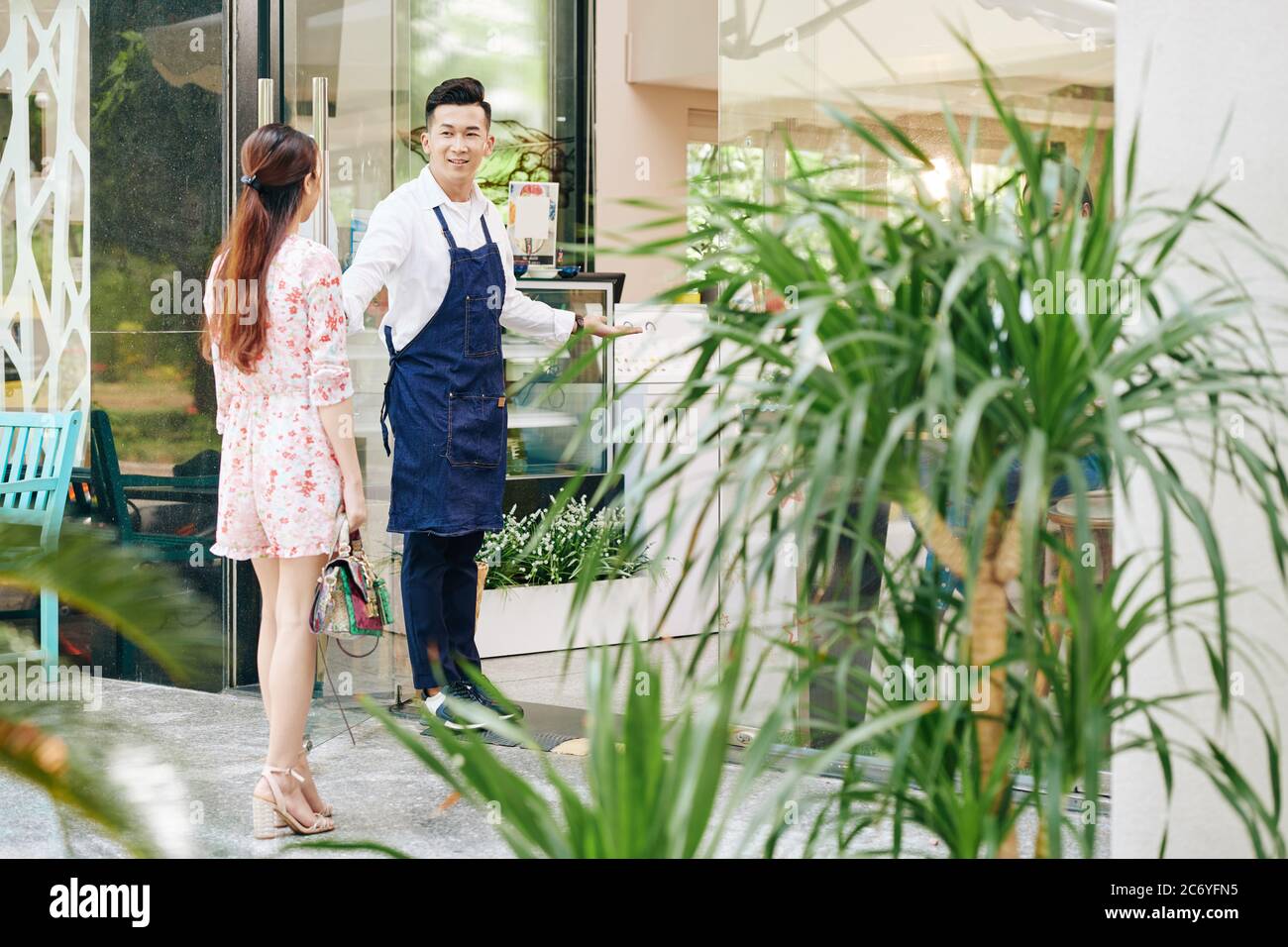 Woman welcoming at door hi-res stock photography and images - Alamy