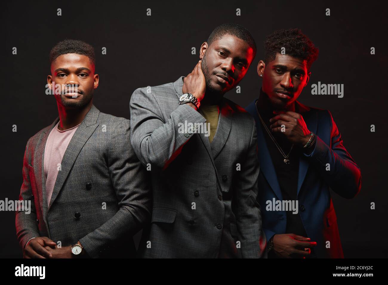Positive african ethnicity businessmen, well-dressed business partners wearing stylish suits looking at camera isolated in studio. Business Apparel, F Stock Photo