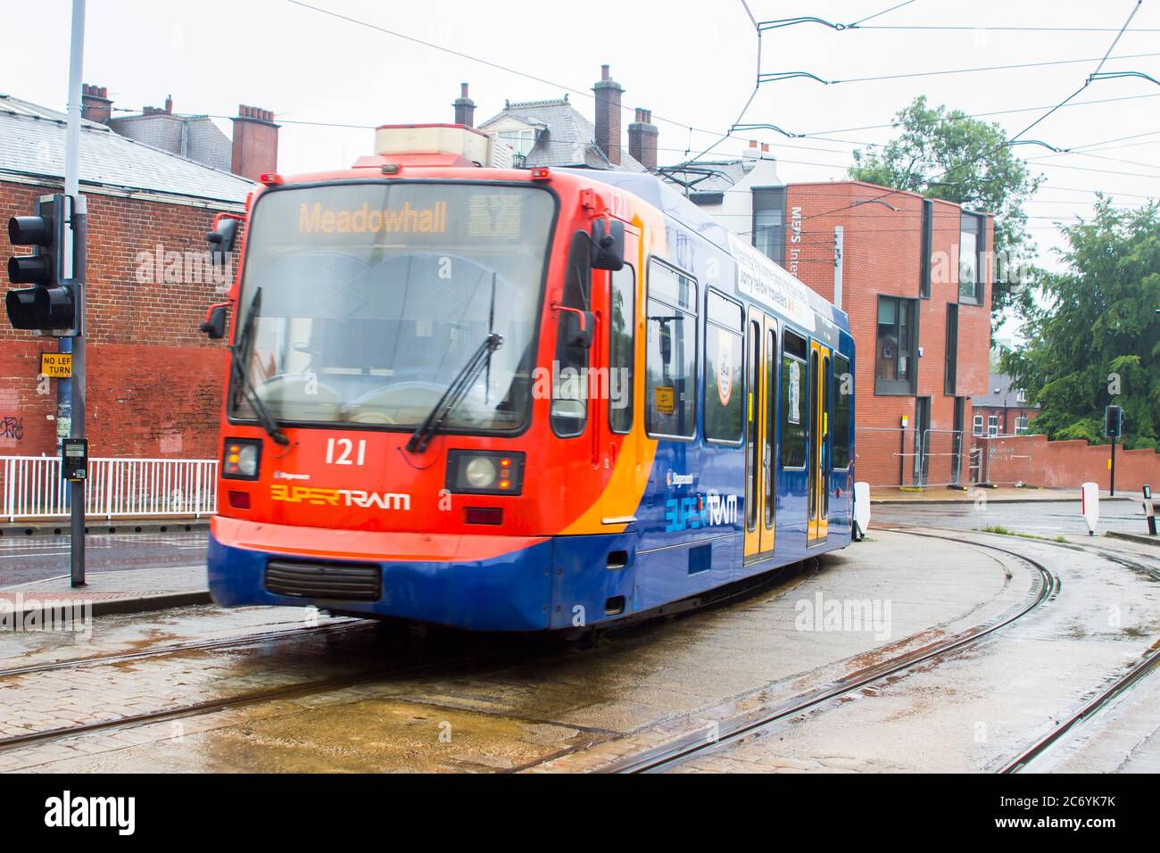 8 July 2021 This inward bound Sheffield Stagecoach Supertram at a stop on a wet misty day is one of a fleet of Siemens-Duewag Supertrams in operation Stock Photo