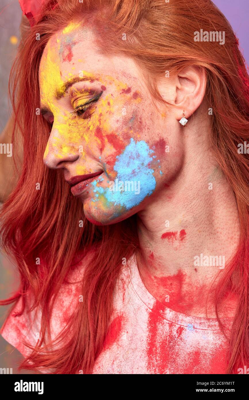 fashion stylish colorful female face. profile of beautiful woman with painting smears, abstract makeup. Multicolor creative make-up. Stock Photo