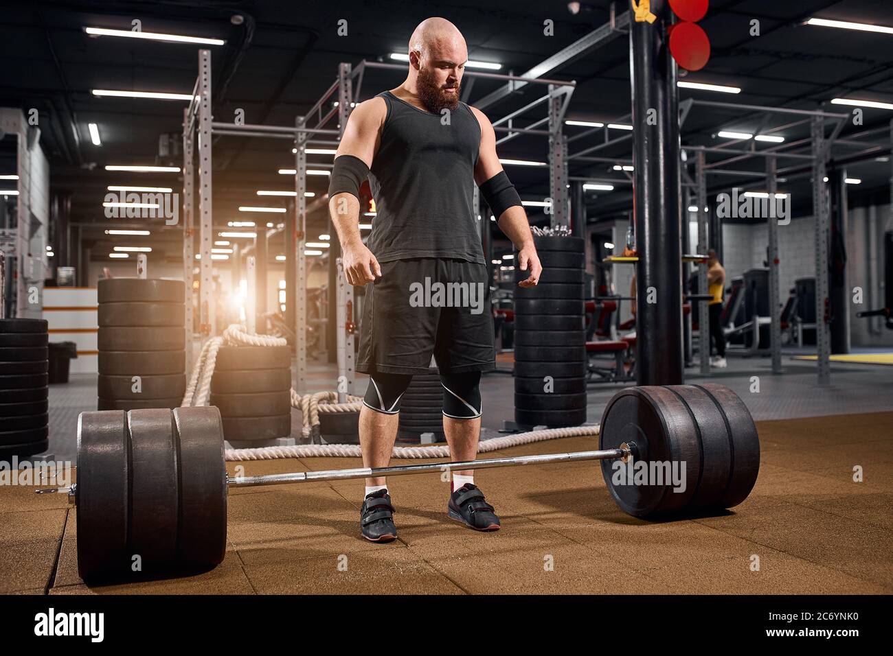 Delighted strong powerlifter spends time in fitness studio, training in