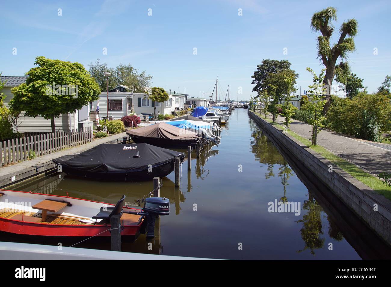 Holiday bungalows, boats and marina in the Dutch village Akersloot at the Alkmaardermeer lake. Netherlands, May Stock Photo