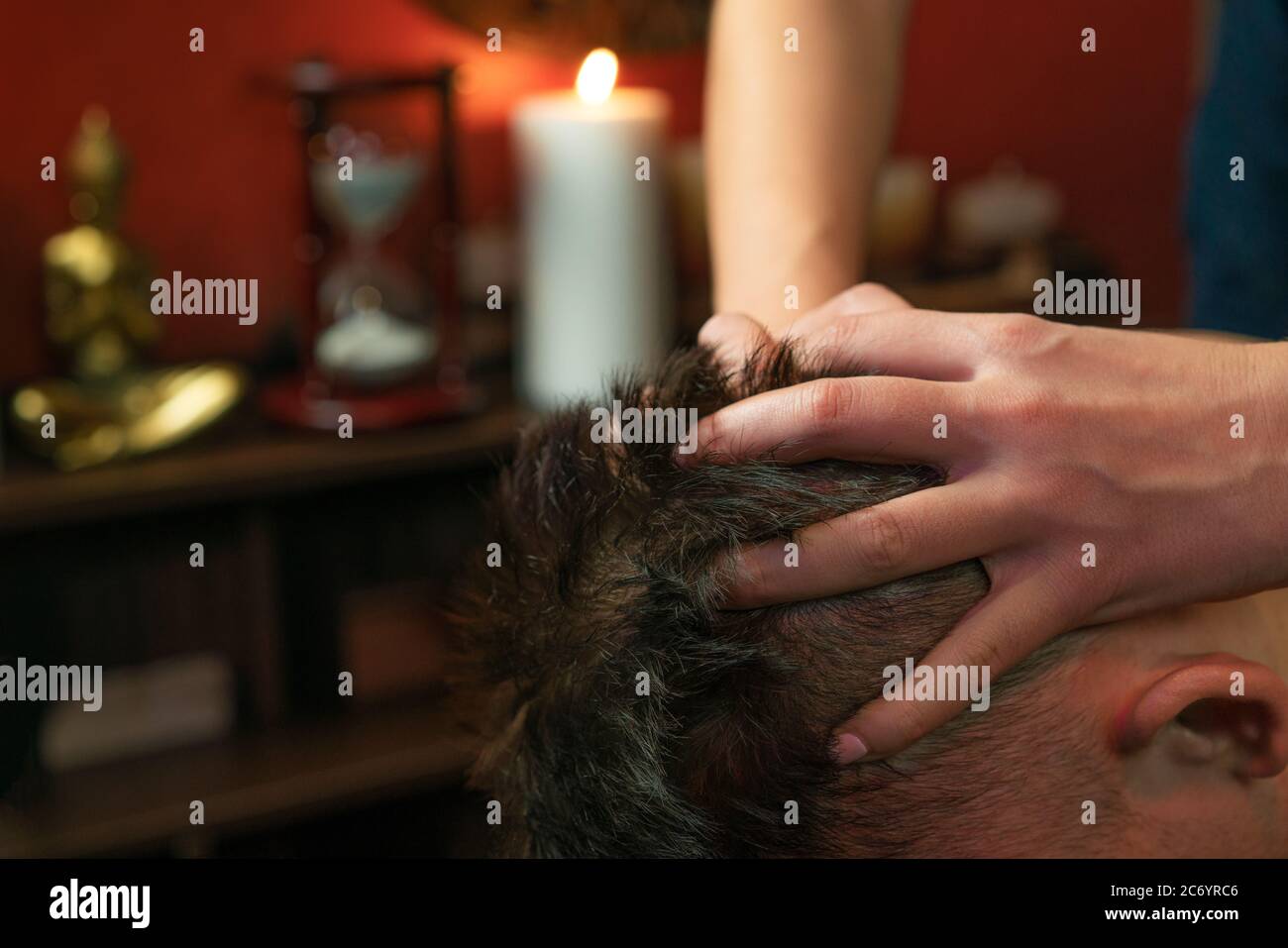 Thai woman gives a man a head massage Stock Photo