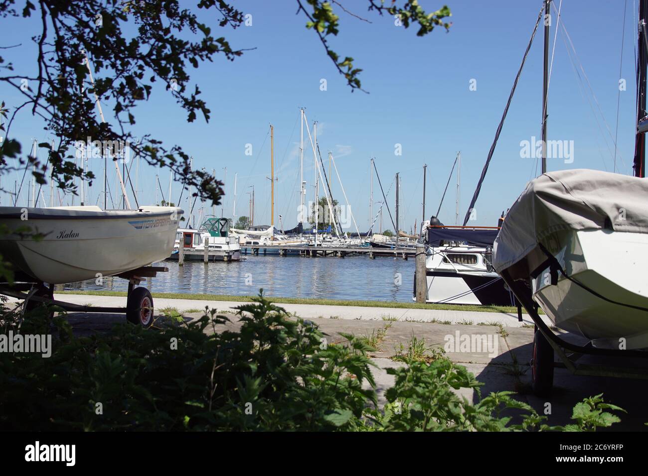 Marina with sailing ships at the Alkmaardermeer Lake in the Dutch village of Akersloot..Netherlands, May Stock Photo