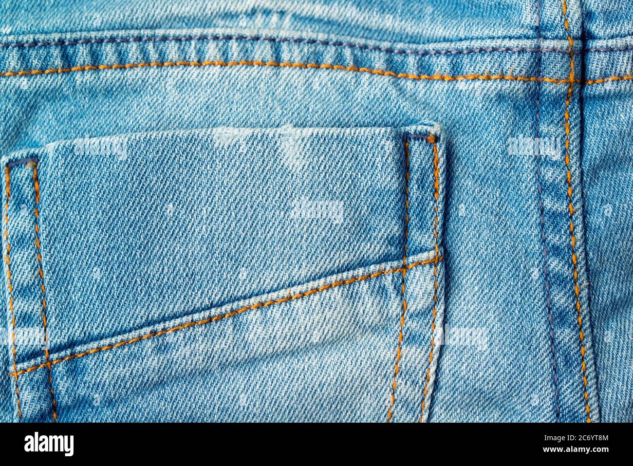 Back pocket of light blue new jeans, textile background Stock Photo