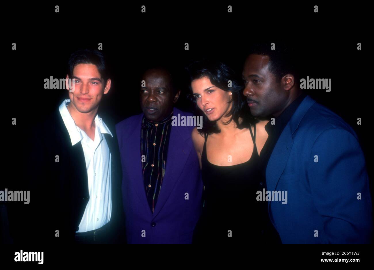 Universal City, California, USA 15th December 1995 (L-R) Actor Eddie Cibrian, singer Lou Rawls, actress Angie Harmon and actor Gregory Alan Williams attend Baywatch & Baywatch Nights Holiday Party on December 15, 1995 at B.B. King's Blues Club in Universal City, California, USA. Photo by Barry King/Alamy Stock Photo Stock Photo