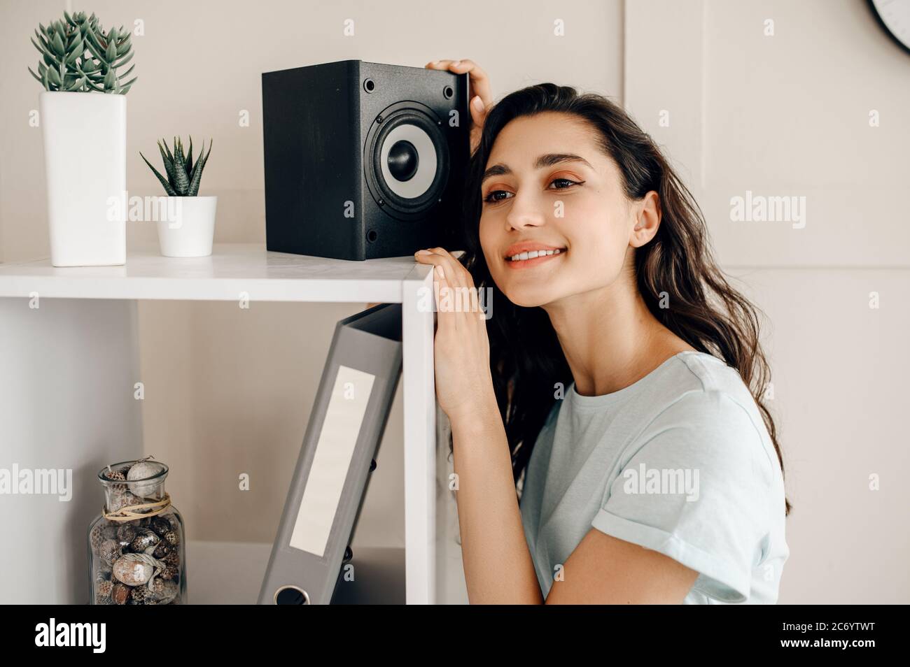 Cute woman against audio speaker listen to music Stock Photo - Alamy