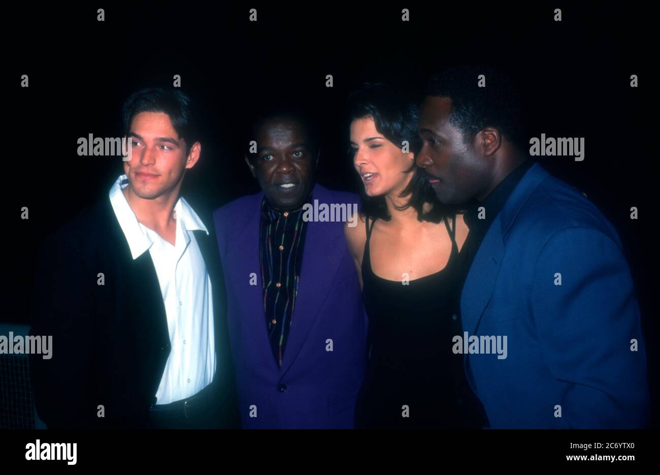Universal City, California, USA 15th December 1995 (L-R) Actor Eddie Cibrian, singer Lou Rawls, actress Angie Harmon and actor Gregory Alan Williams attend Baywatch & Baywatch Nights Holiday Party on December 15, 1995 at B.B. King's Blues Club in Universal City, California, USA. Photo by Barry King/Alamy Stock Photo Stock Photo