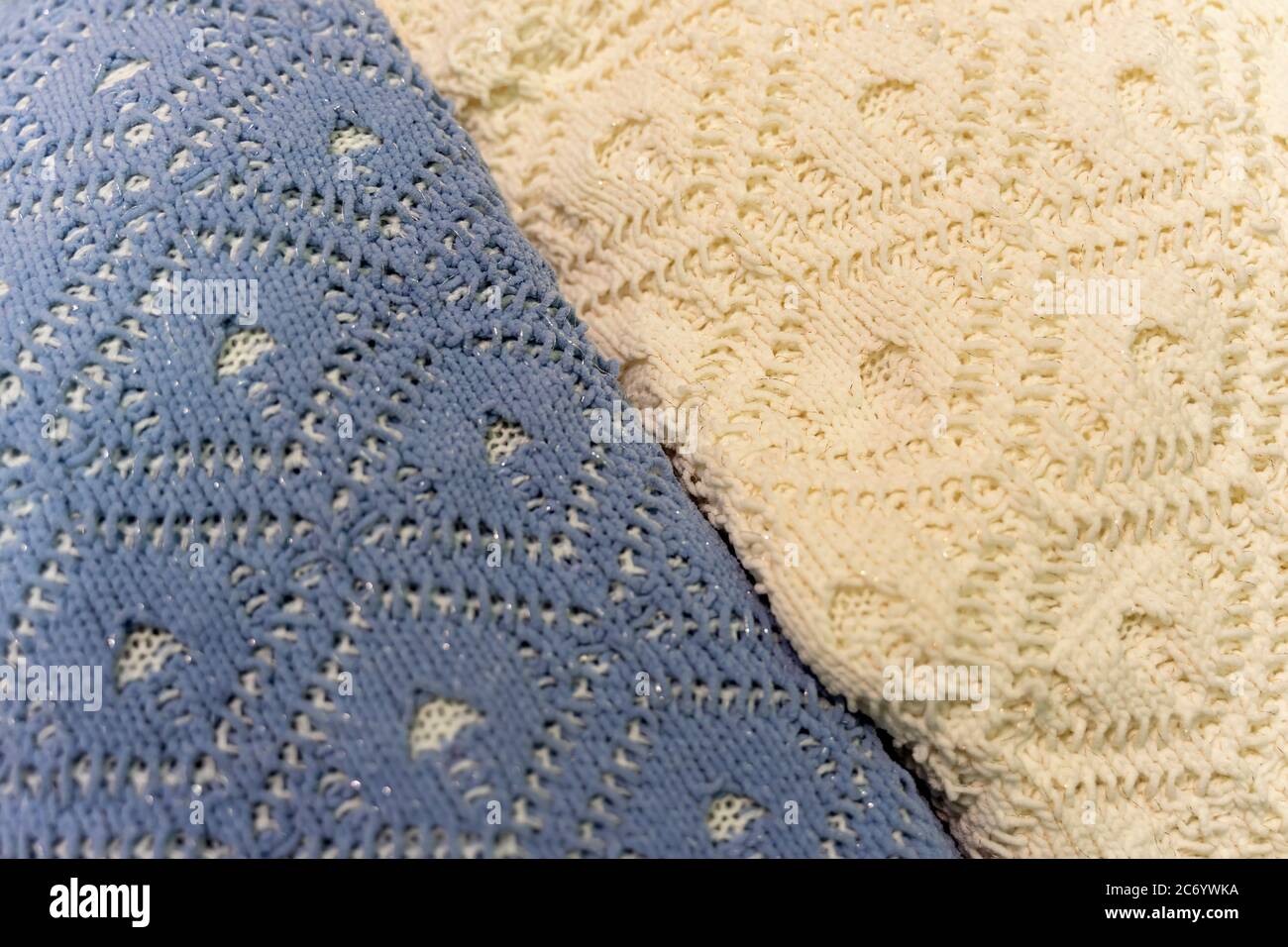 Two pullovers of different colors, knitted wool textures, winter background. Stock Photo