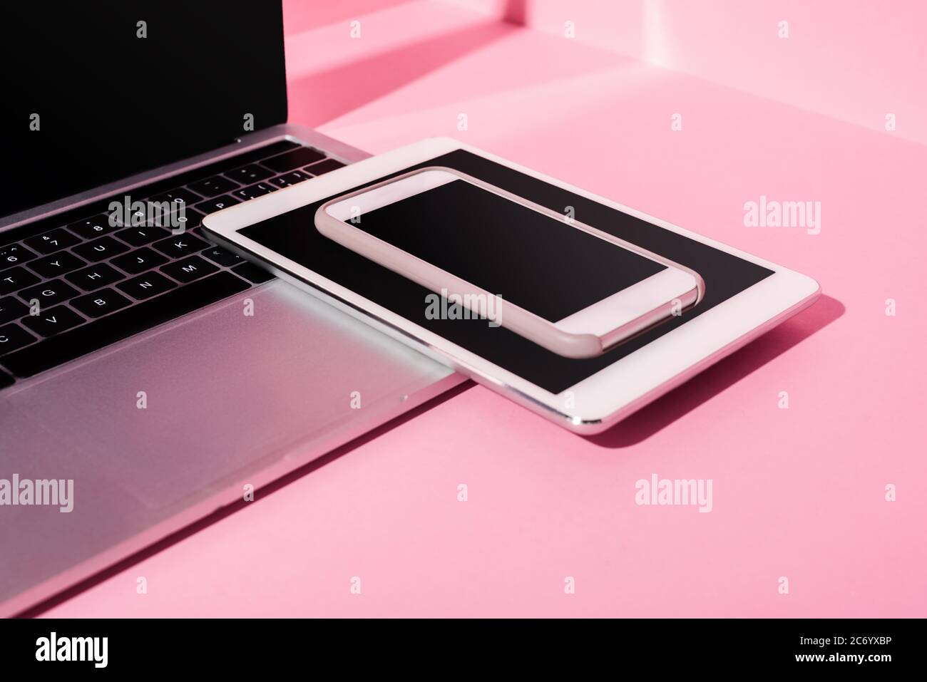modern gadgets with blank screens on pink background Stock Photo