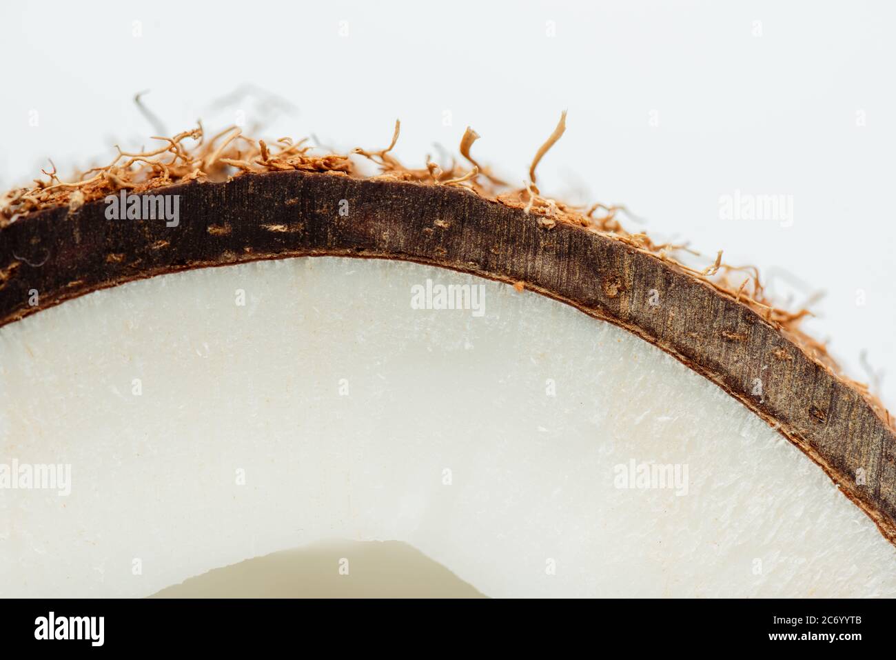 close up view of coconut half with brown textured peel isolated on ...