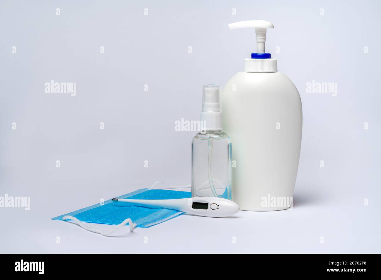 bottle of lotion, sanitizer or liquid soap, electronic thermometer and