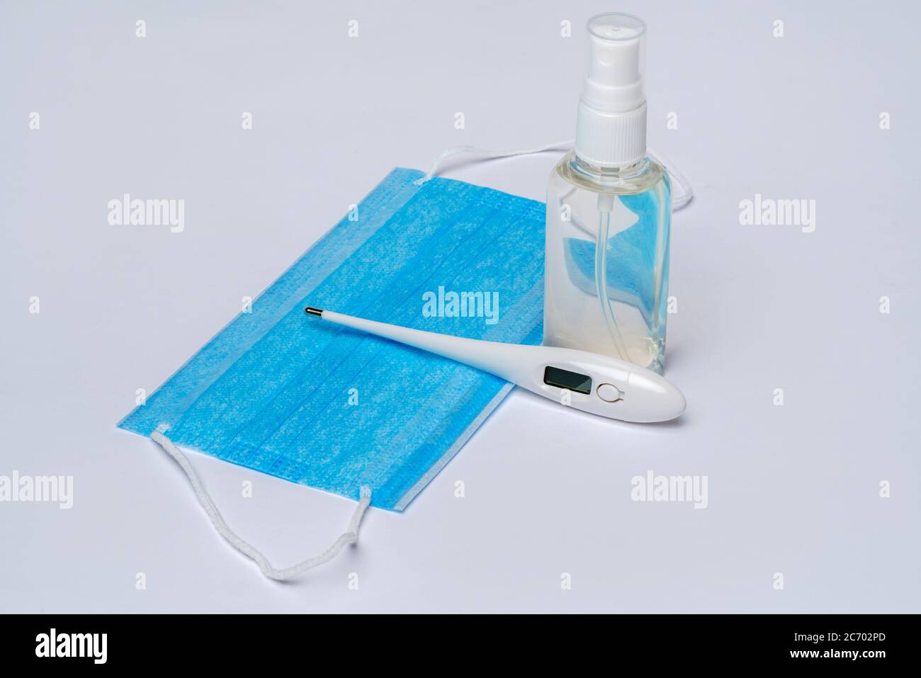 bottle of lotion, sanitizer or liquid soap, electronic thermometer and