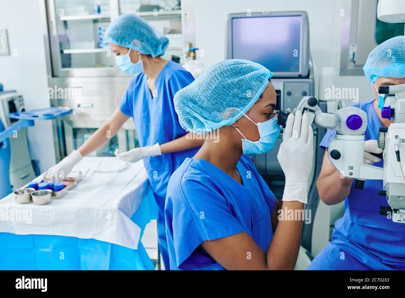 Surgeons performing laser eye vision correction surgery in