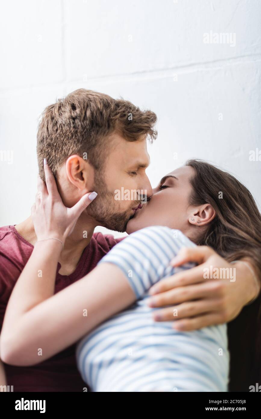 happy young couple hugging and kissing at home Stock Photo - Alamy