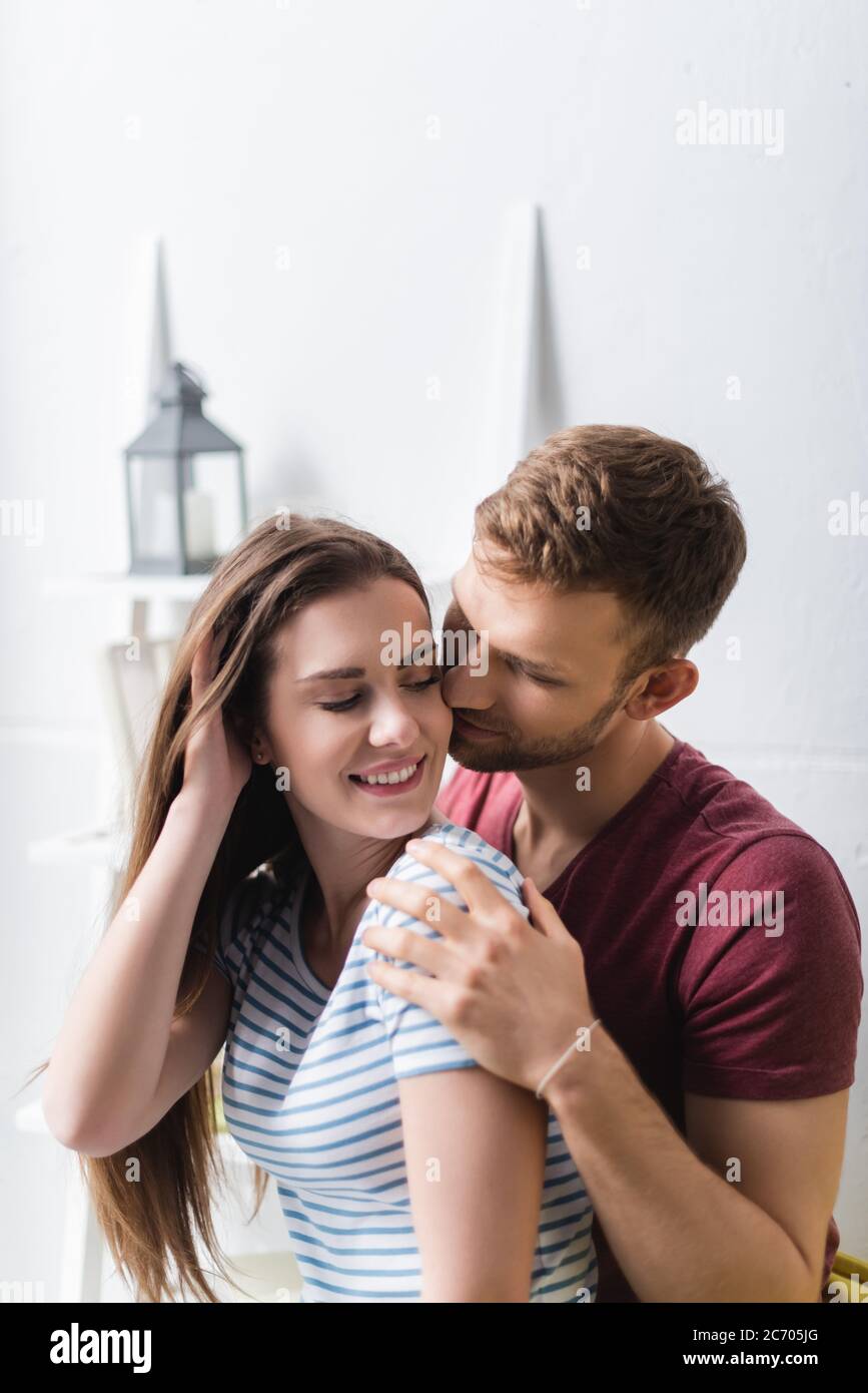 happy beautiful young couple hugging at home Stock Photo - Alamy