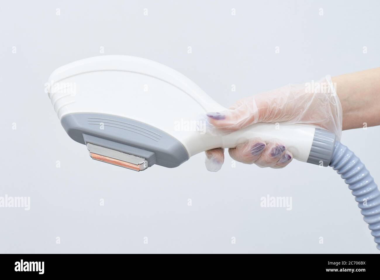 Modern equipment. Laser hair removal. Light background. Personal care