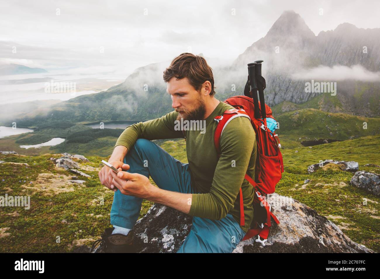 Man hiker using smartphone application navigation in mountains travel  blogger influencer lifestyle hiking adventure summer trip outdoor  backpacking in Stock Photo - Alamy